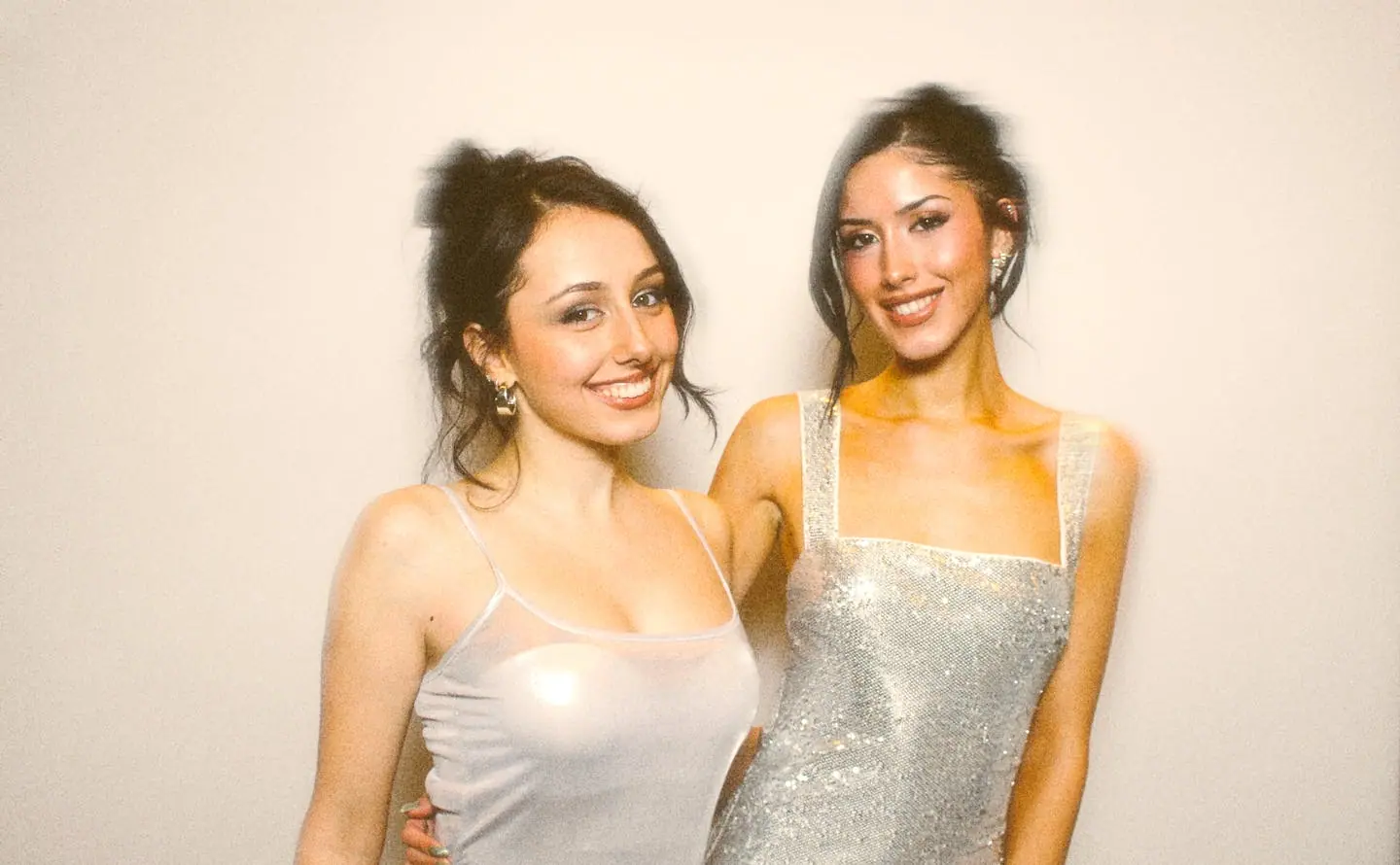 Two guests in silver dresses posing at the Viva photo booth