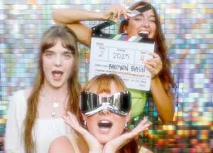 Three friends having fun with lots of props to take an incredible photo.