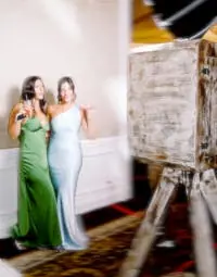 2 wedding guests posing in front of the PhotoBooth