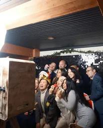 A group of colleagues posing in front of the photo booth at a corporate event