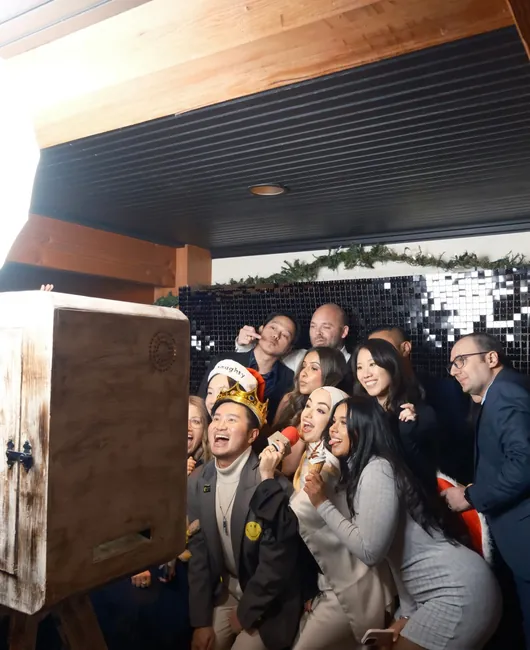 Colleagues with props at the photo booth