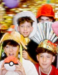 A group of children posing in front of the photo booth for a birthday party.