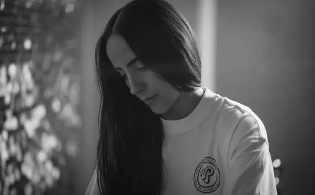 Viva host portrait in a Viva t-shirt, black and white